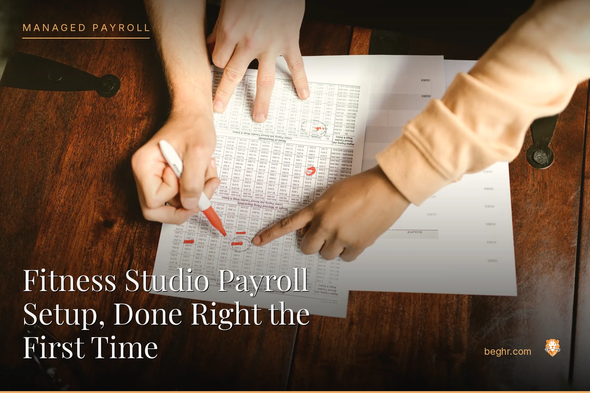Business professionals reviewing payroll and HR documents in a bright modern office